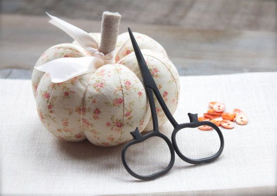 A pair of compact 3.75-inch embroidery scissors with handles uniquely shaped like pumpkins. The scissors feature a rustic matte black finish and large, comfortable finger holes, reflecting a traditional blacksmith-forged aesthetic perfect for needlework and fiber arts