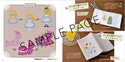Cross-stitch pattern book with illustrations and text on a wooden surface