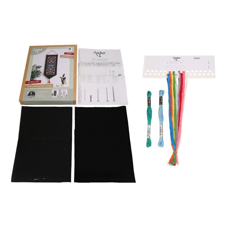 A cross-stitch kit from the Anchor Essentials collection featuring a symmetrical folk-art floral pattern. The image showcases vibrant pinks, yellows, and blues of Anchor stranded cotton threads against a deep black 14-count Aida cloth, highlighting the modern and festive aesthetic of the Maggie Magoo design