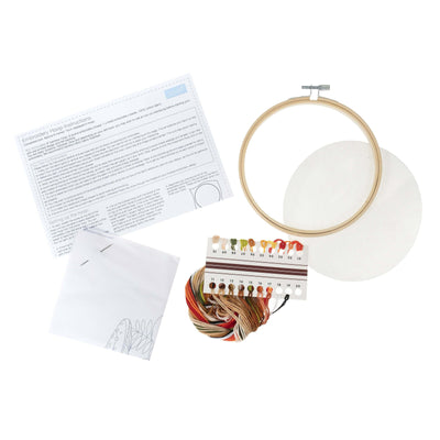 Embroidery kit with hoop, thread, and instructions on a white background