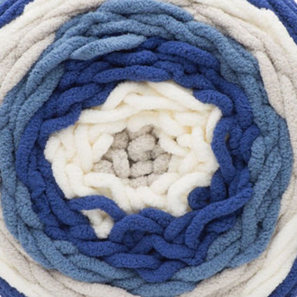A skein of Bernat Blanket Stripes yarn in blue and white colors.