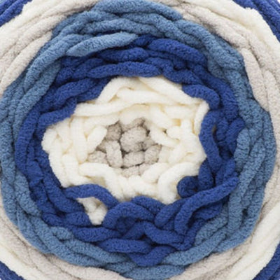 A skein of Bernat Blanket Stripes yarn in blue and white colors.