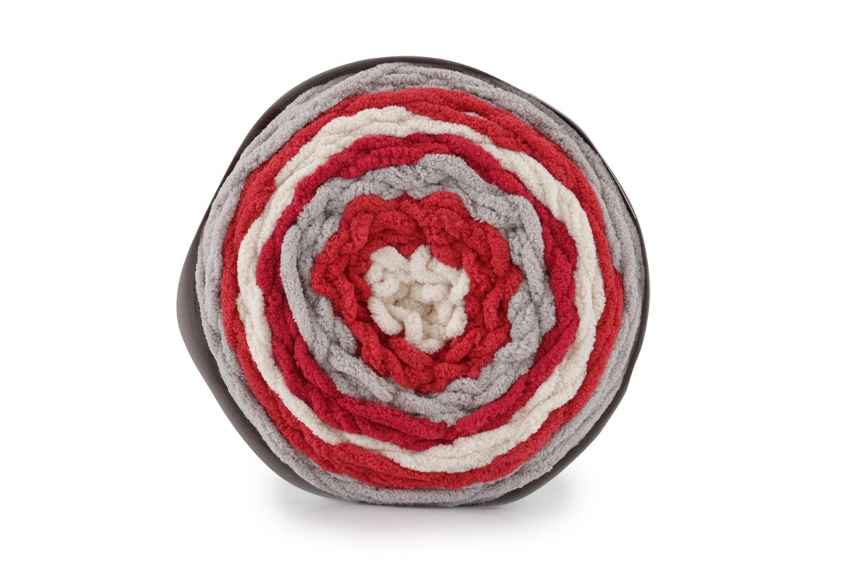 A skein of Bernat Blanket Stripes yarn in red, gray and white colors.