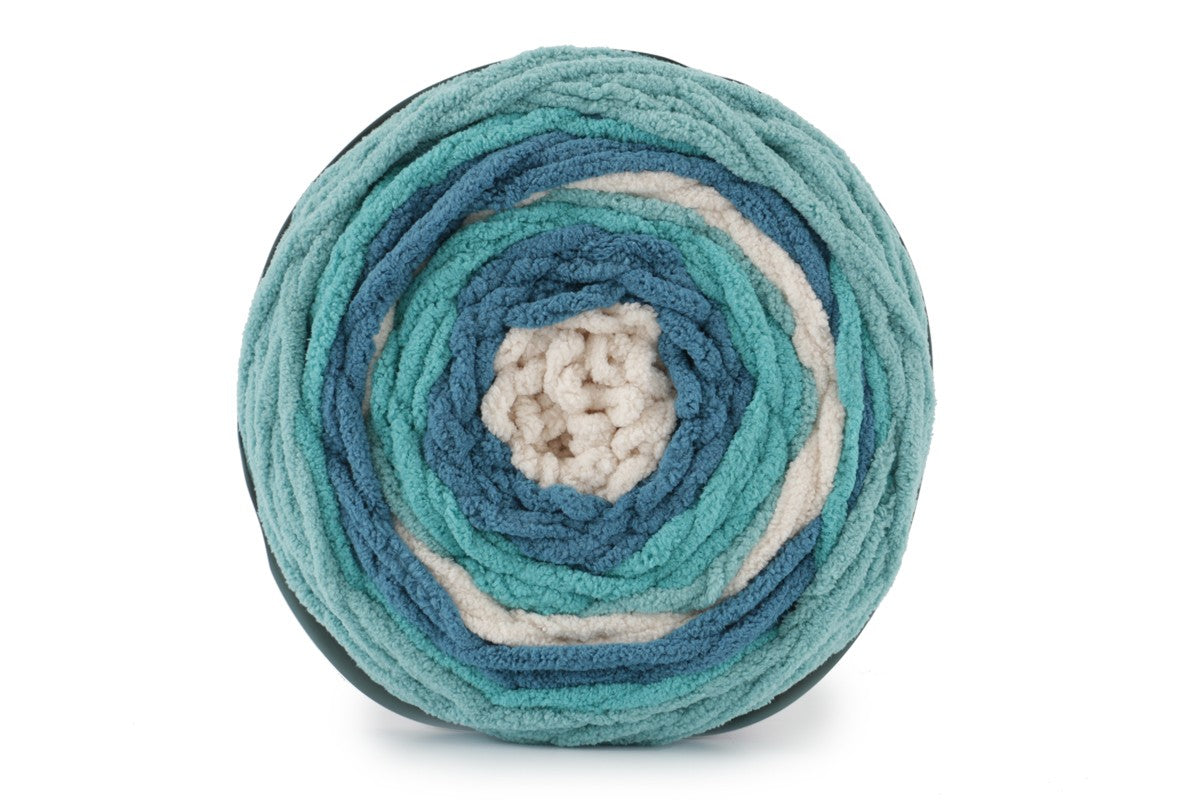 A skein of Bernat Blanket Stripes yarn in teal, blue and white colors.