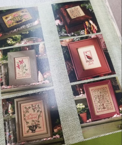 A softcover embroidery pattern book, "Peppermint & Holly," containing multiple cross stitch charts for seasonal home decor, including small pillows and traditional samplers.