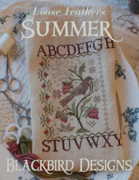 A professional-grade cross-stitch chart by Blackbird Designs titled 'Loose Feathers - Summer,' identified as Part 1 of 3 in the seasonal series. The high-definition design features a soulful, primitive-style bird surrounded by artisanal summer-themed motifs, including stylized florals and vintage-inspired borders. The chart is printed in Blackbird Designs' signature boutique style, intended for use with high-quality linens and hand-dyed or DMC threads. The aesthetic is warm and earthy, capturing a timeless