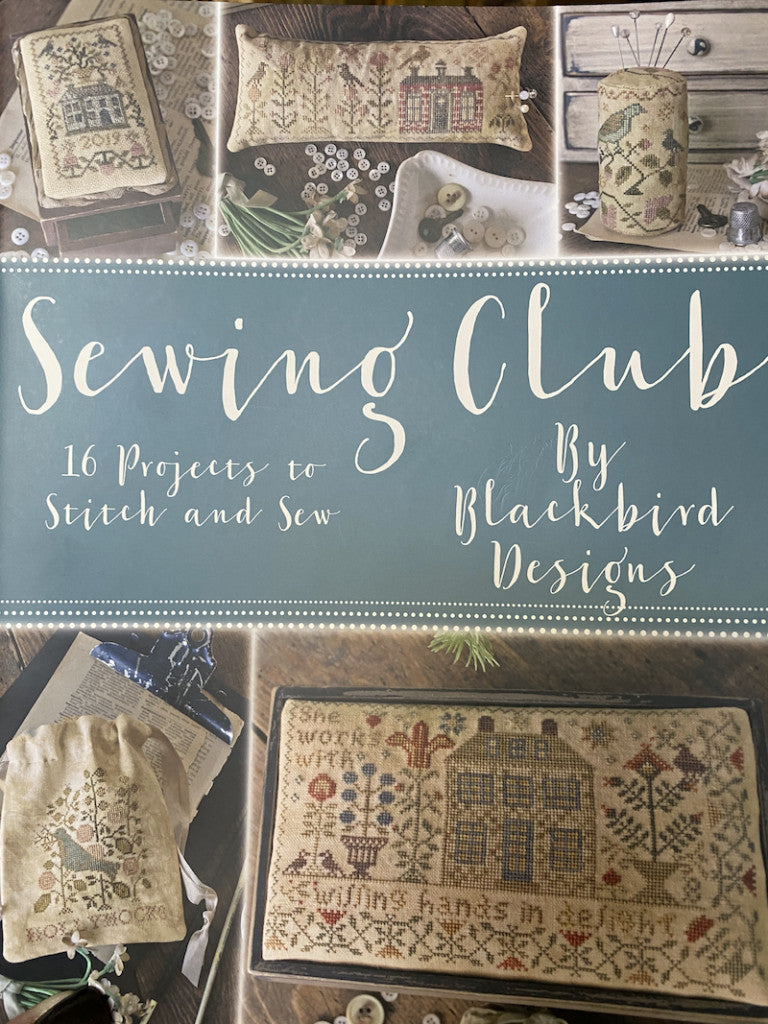 A professional-grade, multi-project booklet by Blackbird Designs titled 'Sewing Club.' The high-definition cover showcases a curated collection of artisanal sewing accessories, including pincushions, needle books, and small samplers in a soulful, vintage-inspired aesthetic. The style is quintessentially Blackbird Designs: muted, sophisticated earth tones with an emphasis on timeless, high-quality craft room decor."