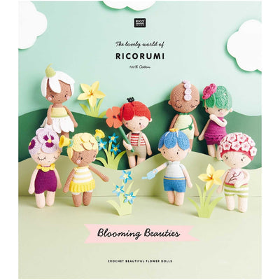Crocheted dolls with detailed written pattern with colorful hair and outfits on a green background with flowers, featuring the brand 'Ricorumi'.