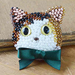 Calico Cat beaded crochet kit including shimmering grey beads, soft cotton thread, and a step-by-step pattern to create a beaded cat charm