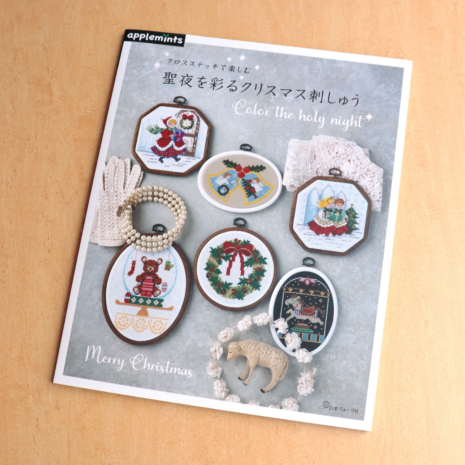 Front cover of the Christmas Collection Cross Stitch Book featuring a beautifully stitched holiday wreath and traditional winter scene.