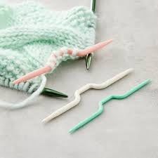 Close-up of a medium Clover cable holder holding several stitches of blue wool yarn in a half-finished cable twist, Clover Cable Stitch Holder, Cable Knitting Needles
