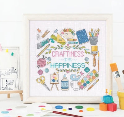 A comprehensive cross stitch book containing multiple charts for creating personalized home decor, including kitchen-themed motifs, welcome signs, and cozy living space patterns.