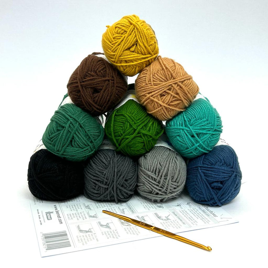 A calming and rustic crochet starter kit featuring ten 50g balls of 100% acrylic yarn in a variety of earth tones, including olive green, burnt orange, slate blue, and warm browns. The kit includes a premium Japanese Tulip double-sided crochet hook (3.0mm/3.5mm) and an English instruction guide, presented as an ideal gift for beginners starting their crochet journey