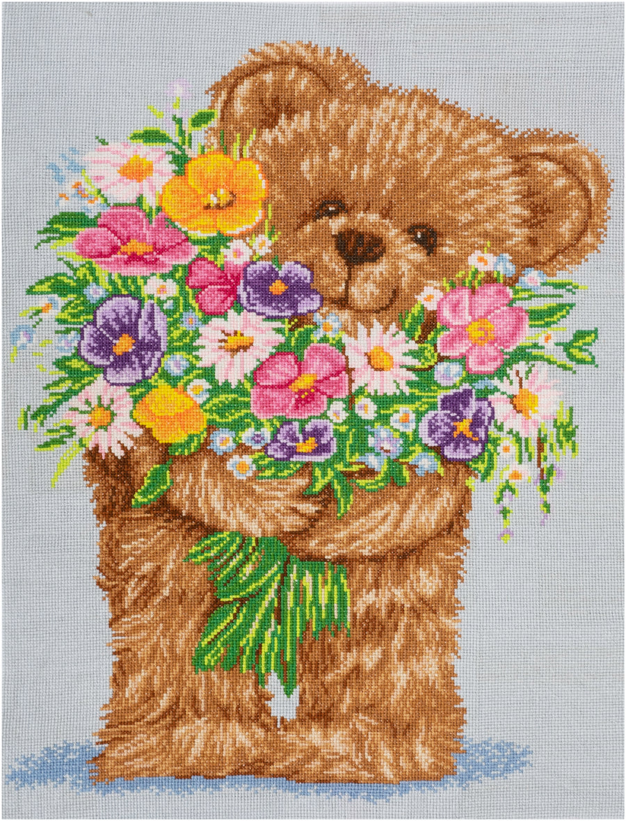 Trimits Mini Cross Stitch Kit featuring a cute Teddy Bear holding a bouquet of colorful flowers. design; an easy starter embroidery kit for kids and beginners with all supplies included.