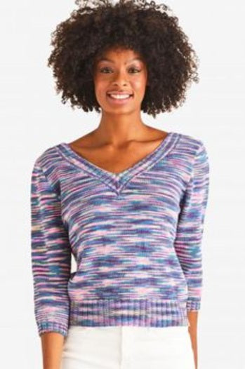 Woman wearing a colorful patterned sweater on a white background using DMC Natura Multico Cotton Yarn | 100% Combed Matte Cotton 50g Variegated Yarn