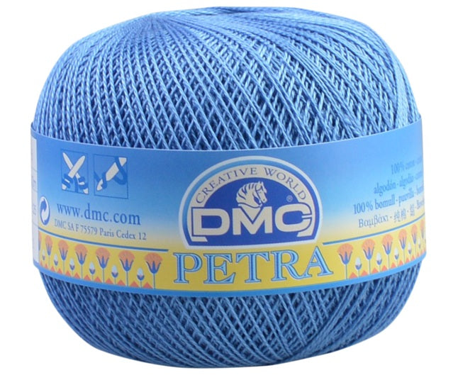 A ball of DMC Petra blue yarn with its original blue and yellow paper label, shown on a plain white background.