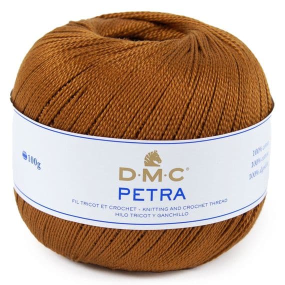 A ball of DMC Petra knitting and crochet thread in a warm brown color, with a white paper label wrapped around it.