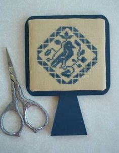Use of Hornbook as a display, specifically designed to act as a showcase for small cross-stitch, embroidery, or needlework masterpieces. The artisanal craftsmanship is evident in the smooth edges and traditional silhouette