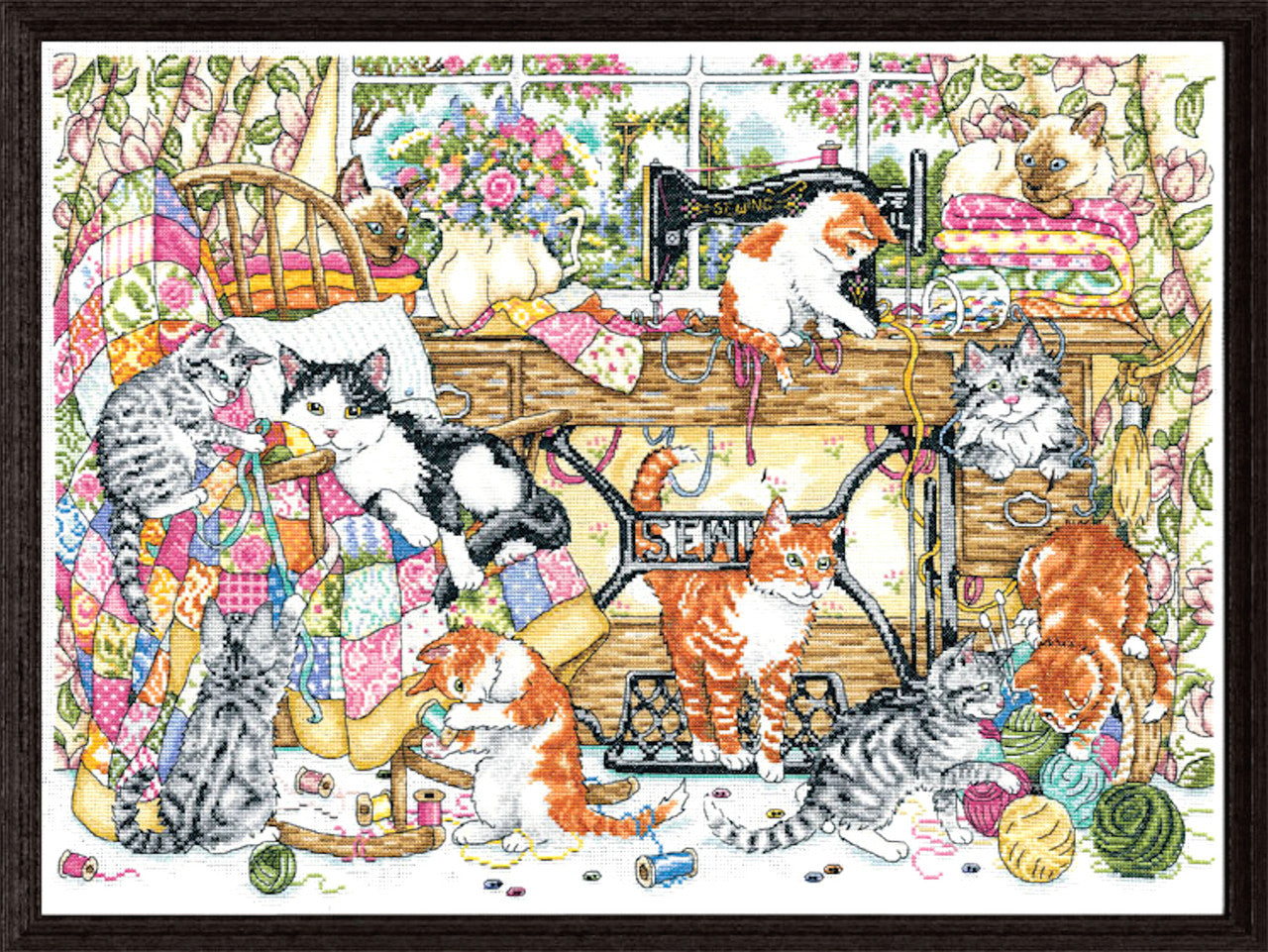 Design Works 'Sew Many Kittens' counted cross stitch kit; a whimsical scene featuring colorful cats playing with sewing notions, buttons, and vintage thread spools