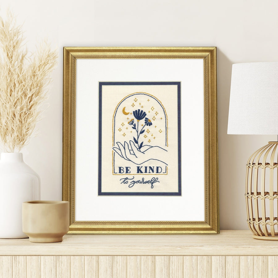 Dimensions Cross Stitch Kit featuring a 'Be Kind to Yourself' floral design with soft pastel threads and ivory Aida fabric.
