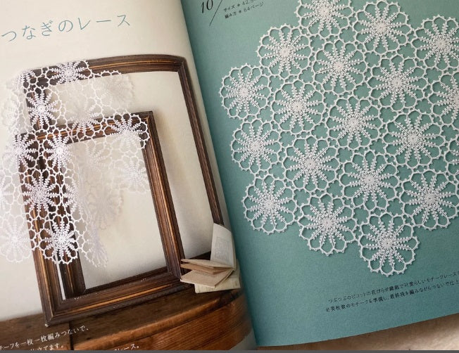 Crochet Lace Book of Patterns by Japan Vogue, featuring an elegant white lace motif on a neutral background.