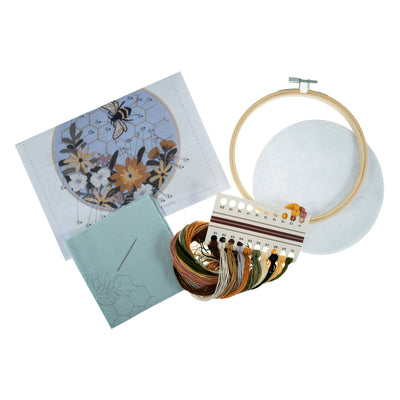Embroidery kit with a detailed bee motif surrounded by flowers, suitable for beginners and hobby stitchers