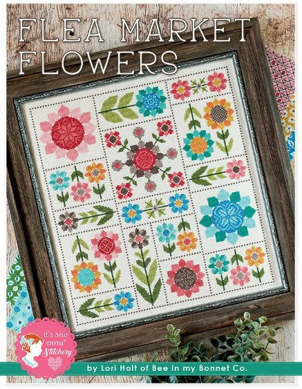 Cross stitch kit depicting a colorful floral pattern in a frame, with the text 'FLEA MARKET FLOWERS' at the top.