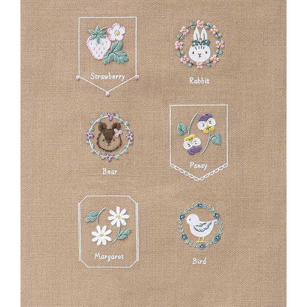 Beginner Friendly Japanese Embroidery, Cosmo Embroidery Floss Kit, Floral Folksy Stitching Project.
A variety of embroidered designs on a yellow background, including a strawberry, a rabbit, a bee, a pomegranate, a daisy, and a bird, each within their own bordered frame.