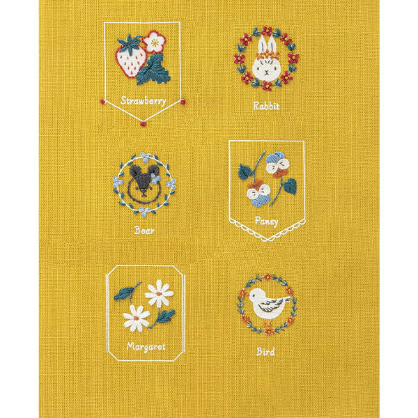Beginner Friendly Japanese Embroidery, Cosmo Embroidery Floss Kit, Floral Folksy Stitching Project.
A variety of embroidered designs on a yellow background, including a strawberry, a rabbit, a bee, a pomegranate, a daisy, and a bird, each within their own bordered frame.