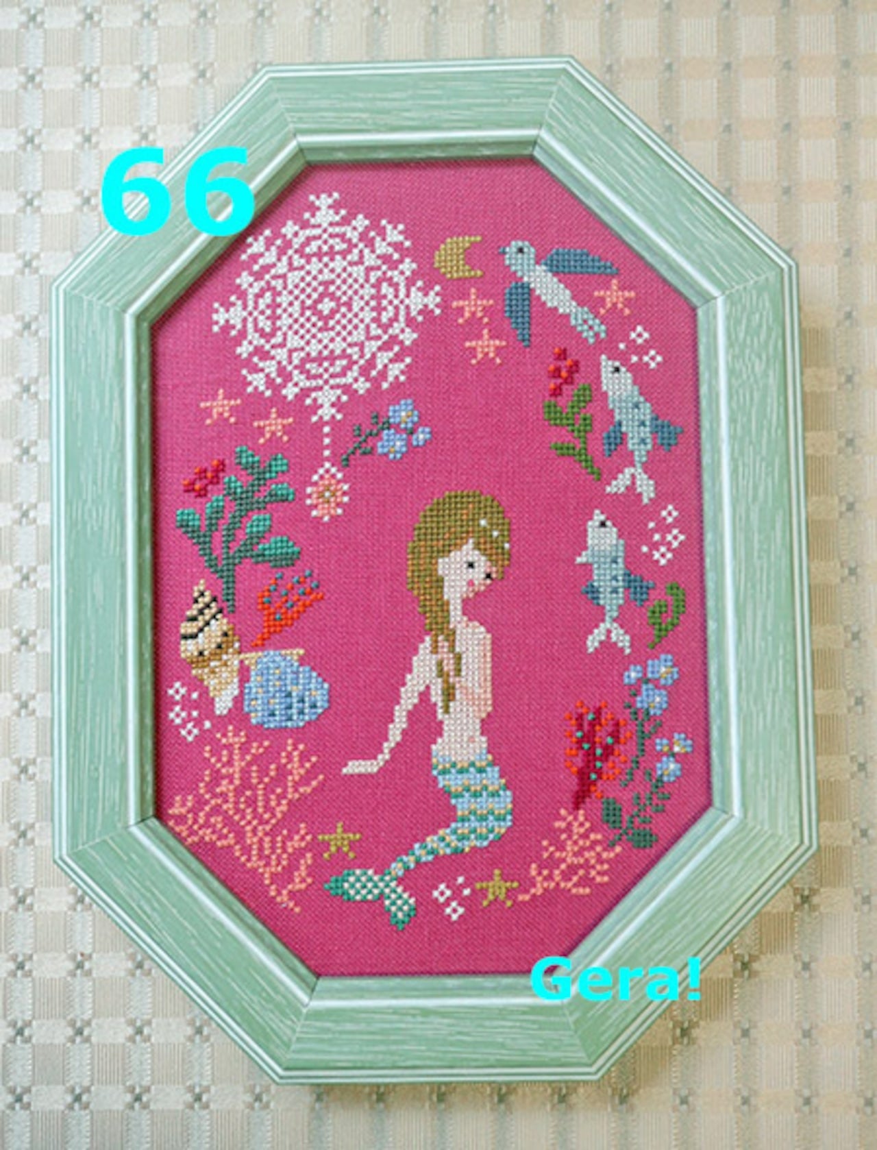A professional-grade counted cross-stitch chart booklet by GERA! designed by Kyoko Maruoka, titled 'The Little Mermaid.' The high-definition cover reveals a whimsical, storybook interpretation of the classic mermaid princess beneath the waves, rendered in a sophisticated, nostalgic pointillism aesthetic. The technical grid layout measures 87 stitches wide by 124 stitches high, capturing intricate marine life, trailing sea flora, and delicate character details.