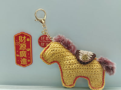 Crocheted horse keychain with decorative elements. Chinese New Year hand crocheted in Singapore artisan made. Small craft shop hand made item for sale.