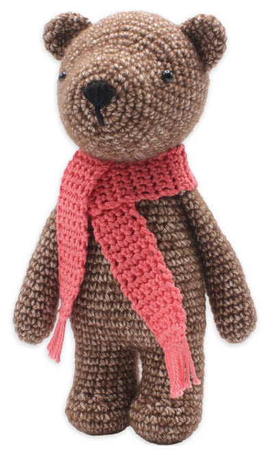 Crochet Brown teddy bear Kit with a pink scarf on a white background.