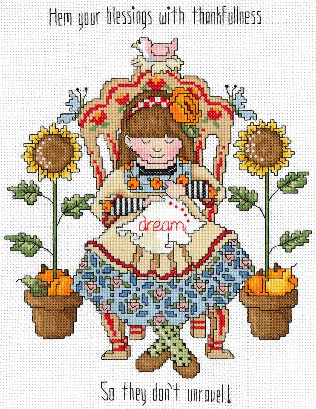 Close-up of the "Hem Your Blessings" embroidery design, showcasing the delicate needlework motifs and the warm, traditional color palette of the included threads.