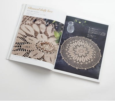 An interior page showing a variety of delicate crochet doilies in different sizes and floral patterns