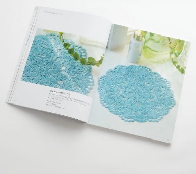 Cover of the Japanese Crochet Lace book showing a stunning, intricate white lace tablecloth on a wooden table