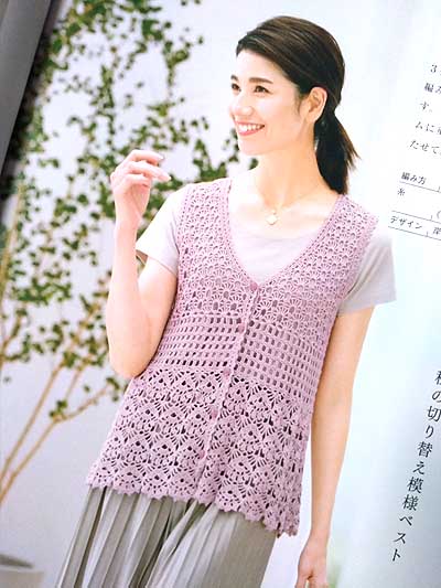 An open book showing a detailed Japanese crochet symbol chart alongside a high-quality photograph of a lightweight, cream-colored lace summer tunic. The page is clean and professional, emphasizing the intricate stitch work and the visual clarity of the instructional diagrams.