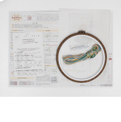 Embroidery hoop with colorful thread on a white background with text and patterns.
A flat-lay of the Olympus kit including the 6-inch wooden-style hoop, large-hole 9-count Aida fabric, colorful threads, and the needle