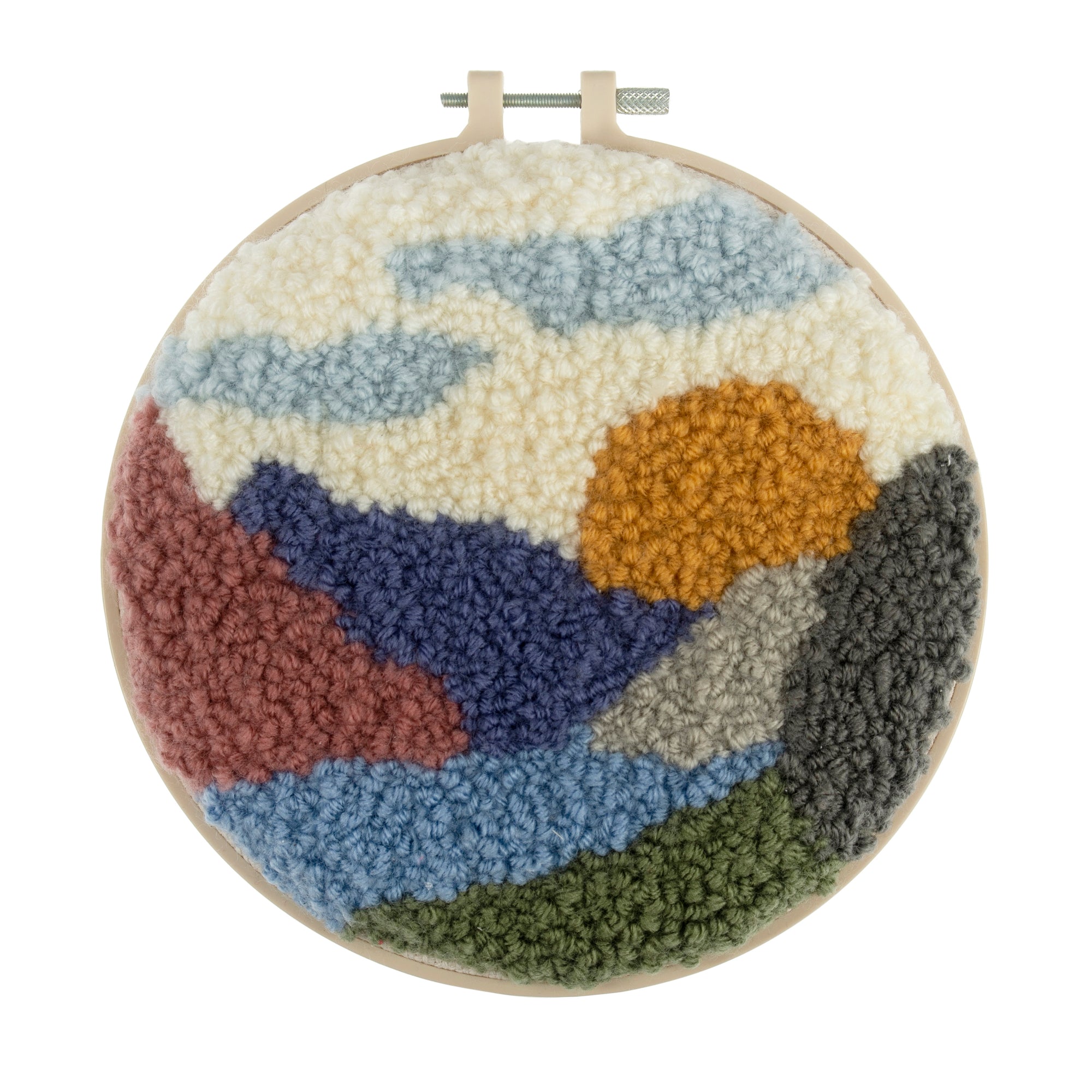 A punch needle hoop kit with a non-slip plastic hoop and a landscape-themed fabric made of cotton and yarns, ready for needlework.