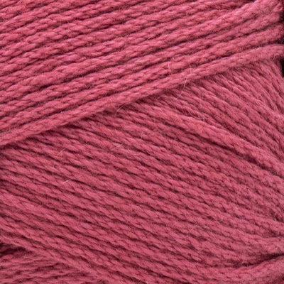 A skein of Lion Brand 24/7 Cotton yarn, highlighting the shiny mercerized finish and tightly plied 100% cotton texture in tetra pink colour