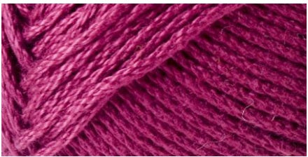 A skein of Lion Brand 24/7 Cotton yarn, highlighting the shiny mercerized finish and tightly plied 100% cotton texture in Magenta colour