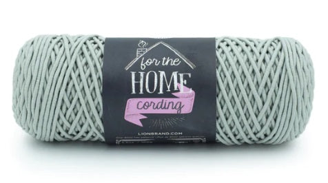 A versatile skein of Lion Brand Cording Yarn, ideal for crocheting and knitting sturdy home items like storage baskets, floor poufs, plant hangers, and decorative placemats in sage green colour