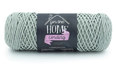 A versatile skein of Lion Brand Cording Yarn, ideal for crocheting and knitting sturdy home items like storage baskets, floor poufs, plant hangers, and decorative placemats in sage green colour