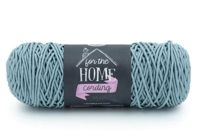 A skein of Lion Brand® For The Home Cording Yarn, a durable and sturdy corded yarn designed for high-wear home accessories, featuring a smooth, snag-resistant texture in sea foam colour