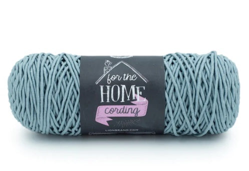 A skein of Lion Brand® For The Home Cording Yarn, a durable and sturdy corded yarn designed for high-wear home accessories, featuring a smooth, snag-resistant texture in sea foam colour