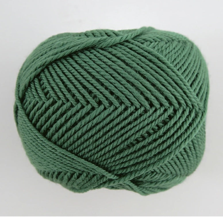 A 30g donut-style ball of Pierrot Fine Merino yarn. The image showcases the smooth, tightly spun plies of 100% Extra Fine Merino wool, reflecting the high-quality Japanese craftsmanship and the soft, matte finish characteristic of premium boutique yarns in ivy green colour