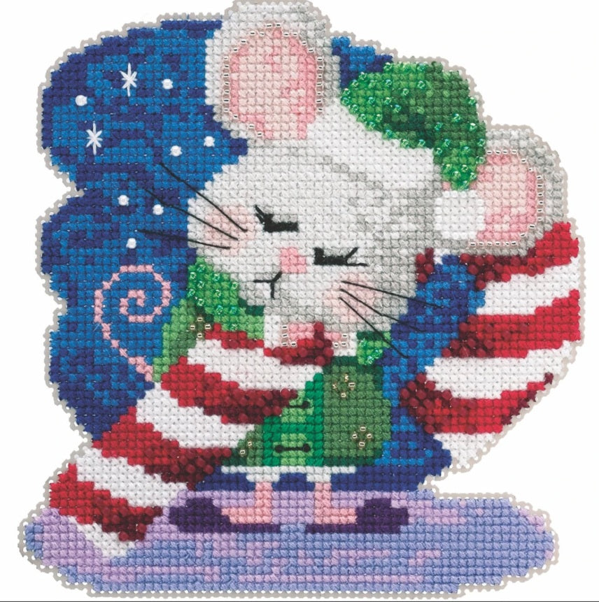 A professional-grade Mill Hill beaded cross-stitch kit titled 'Cindy Cane.' The high-definition holiday ornament features a whimsical candy cane character or themed design, richly embellished with artisanal glass beads. The kit is a complete boutique package containing 14-count painted perforated paper, Mill Hill glass beads, premium embroidery floss, specialized needles, and a clear stitching chart.