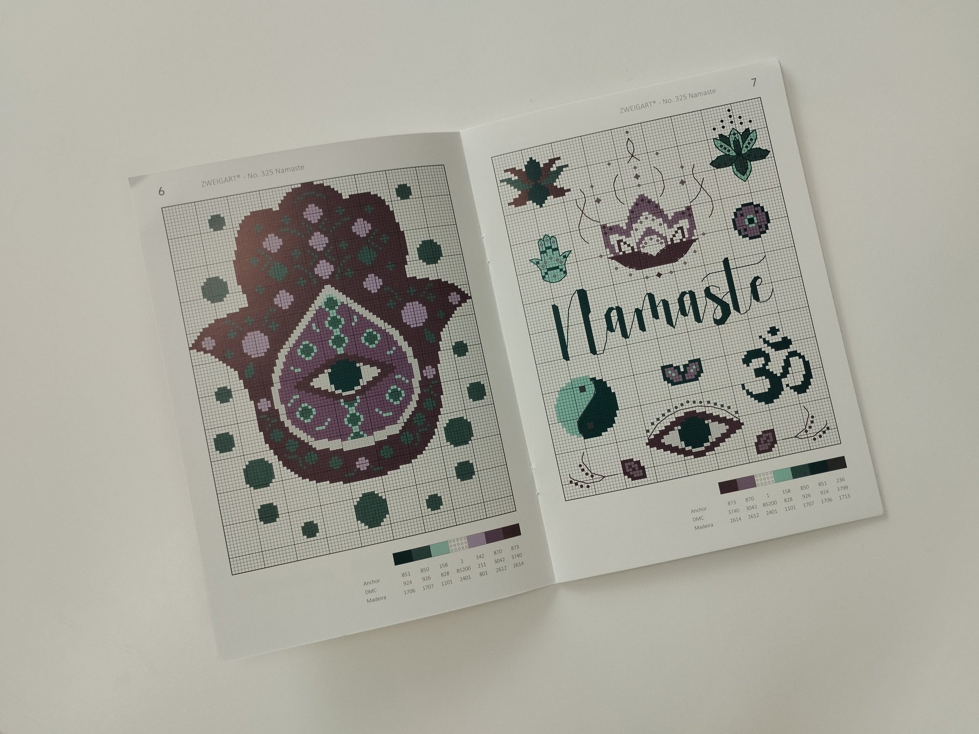 Two cross-stitch pattern sheets on a white background with the word namaste