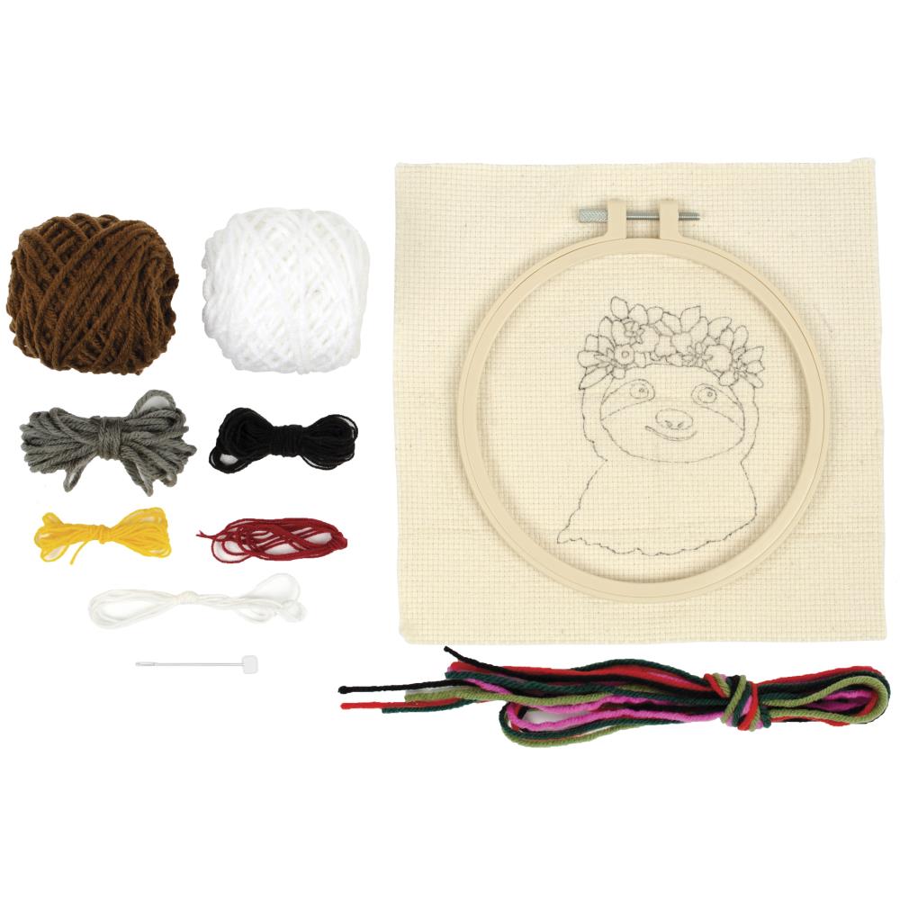 A complete Needle Creation Sloth Punch Needle Kit, featuring a pre-printed fabric panel, an embroidery hoop, vibrant yarn, and a punch needle tool for creating a textured, 3D sloth design.