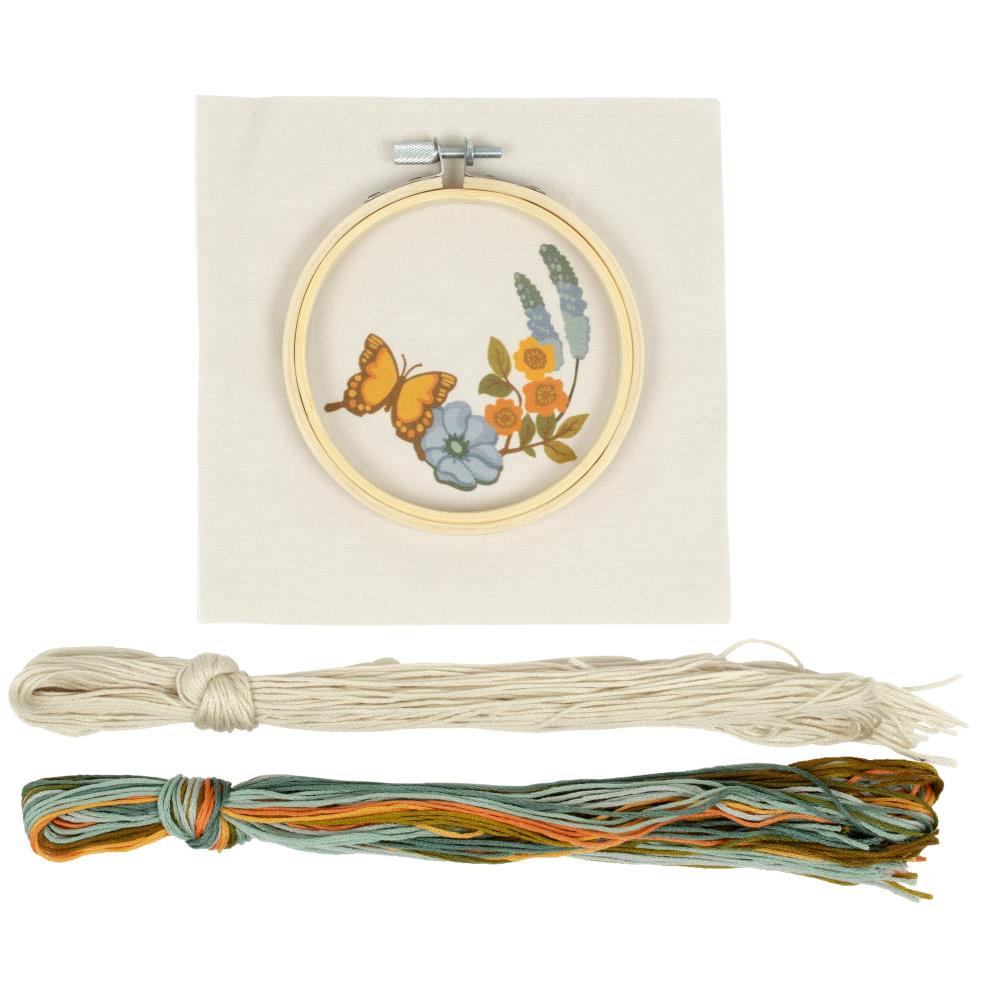 A complete Needle Creations Punch Needle Kit featuring a butterfly and floral design, including a pre-printed fabric panel, an embroidery hoop and colorful threads