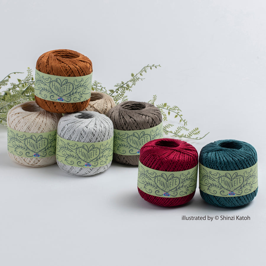 Made in Japan Egyptian Cotton Set of colorful yarn balls with green labels on a light gray background